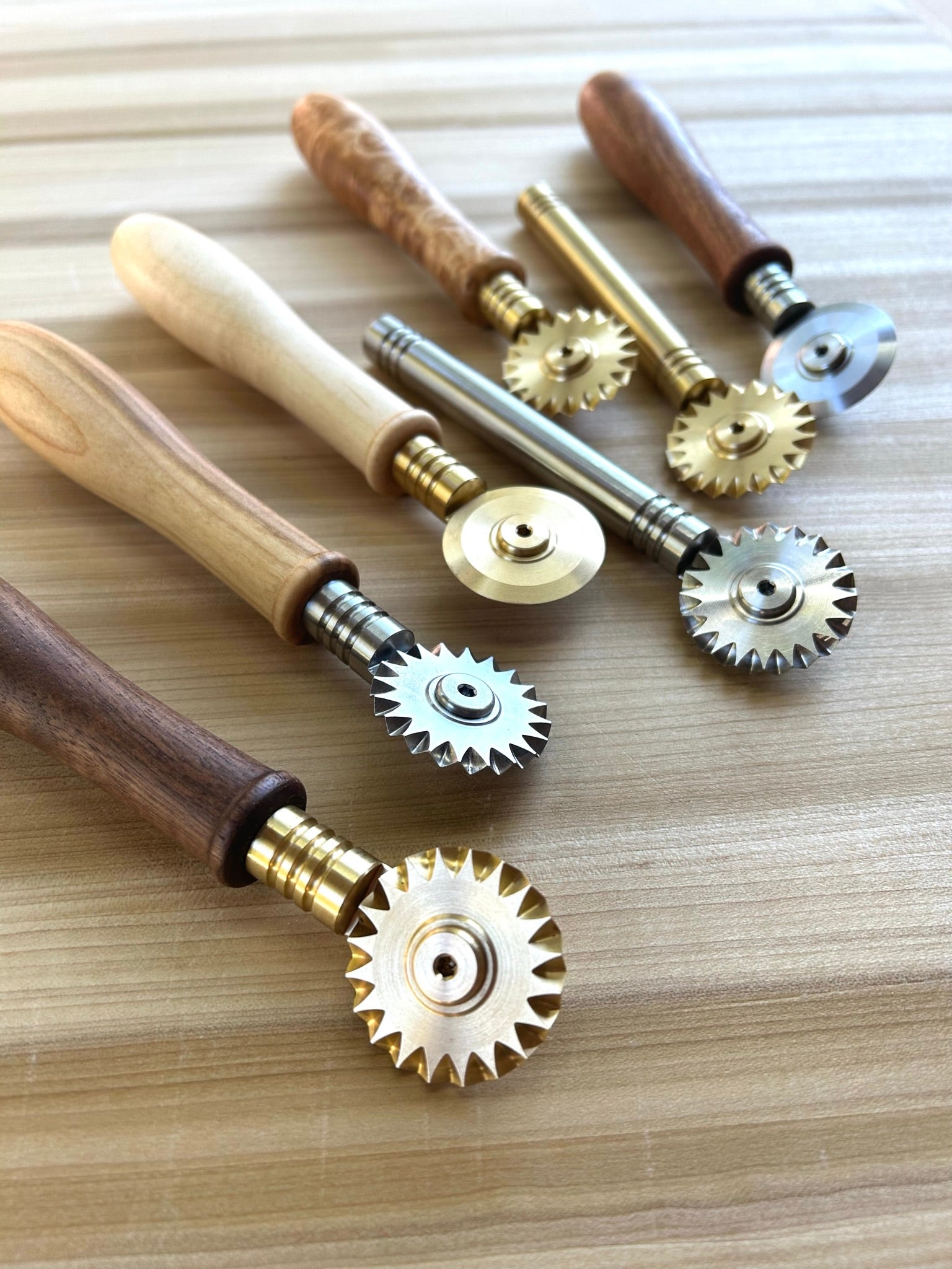 Pasta cutter wheel in brass with single toothed blade, walnut handle